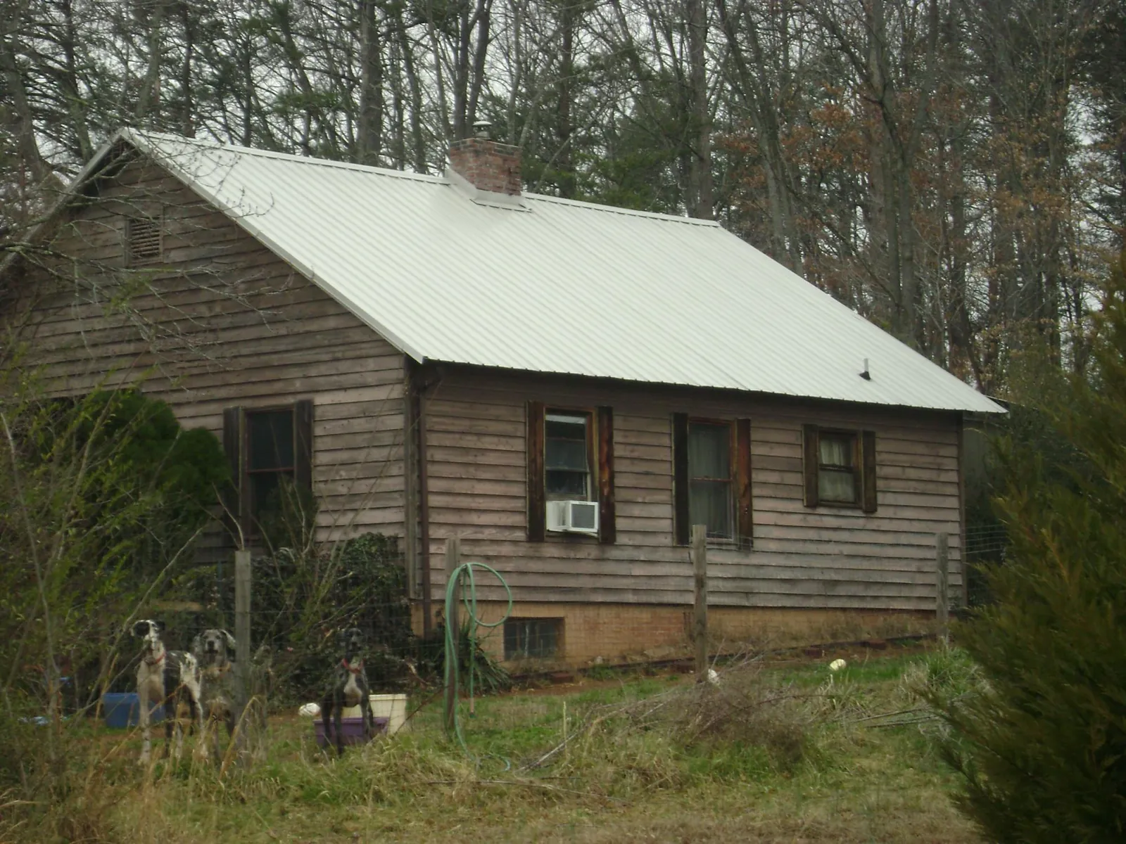 White metal roof on an old wood sided farmhouse, from a Metal Roof Installation job in Port Washington